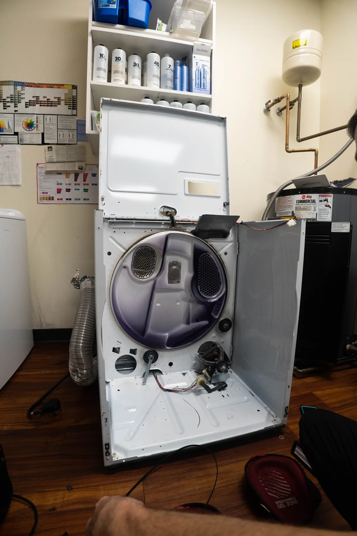 Washing machine opened up for repair on a service bench